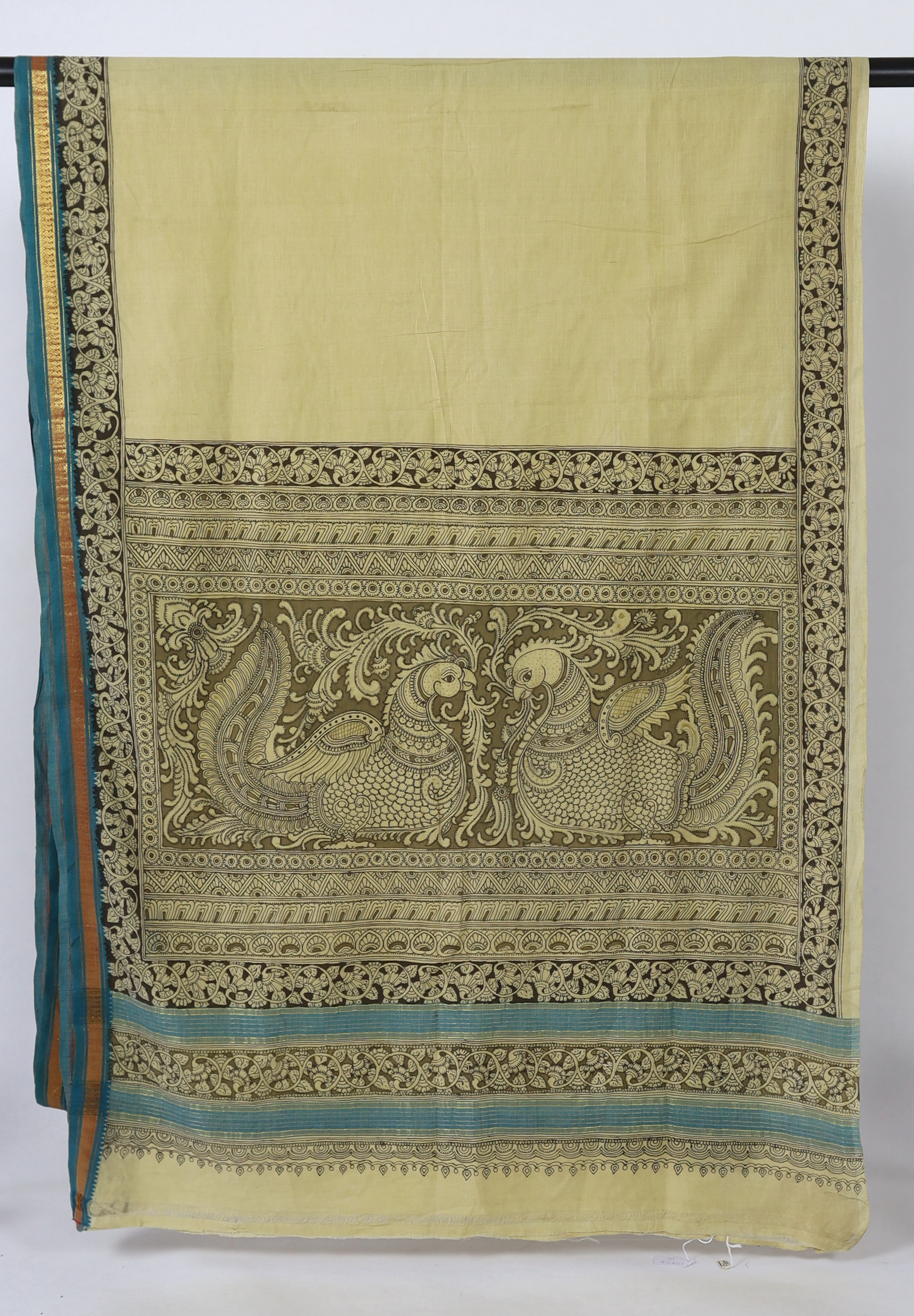 An Indian, Srikalahasti (north of Madras), 'Kalamkari' (penwork) sari, worked and designed by Krishna Reddy. This penwork design, chiefly used for huge temple hangings, is free drawn, with the fabric spread in the sun to